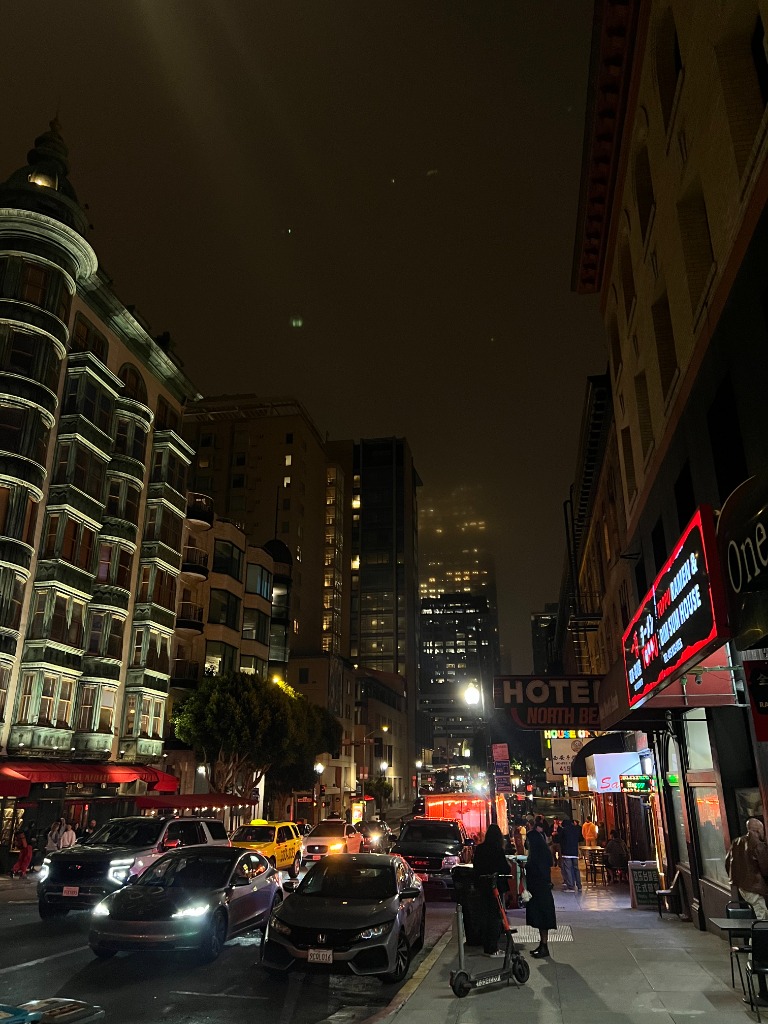 North Beach street scene at night with neon signs and city lights